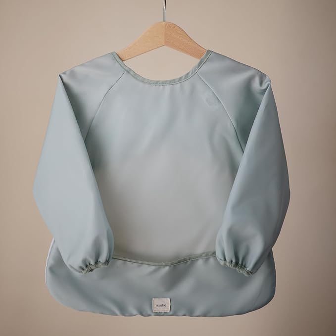 mushie Long Sleeve Baby Bib | Water Resistant Adjustable Fit for Ages 6-24 Months