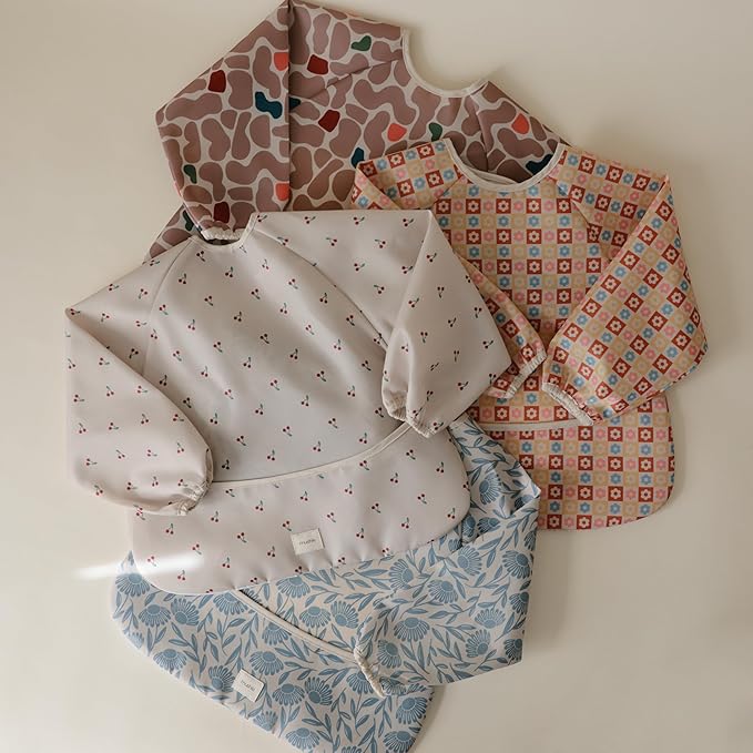 mushie Long Sleeve Baby Bib | Water Resistant Adjustable Fit for Ages 6-24 Months