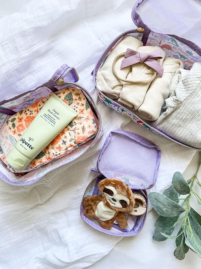 Itzy Ritzy Packing Cubes For Travel – Set of 3 Packing Cubes or Travel Organizers; Each Cube Features a Mesh Top, Double Zippers and a Fabric Handle (Purple Dinosaurs)