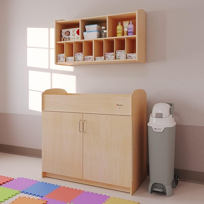 Foundations Serenity Daycare Changing Table with Storage Cubbies, Durable Wood Construction, Built-in Shelving for Ample Storage, Adjustable Safety Strap, Includes 1” Foam Mattress Pad (Natural)